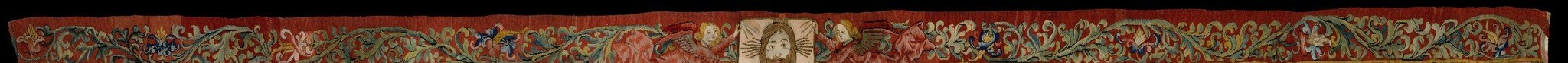 Human portrait medallions hidden inside acanthus or floral borders are a signature detail of late-medieval tapestry , viewers rarely look up to find them; a genuine hidden-detail candidate.