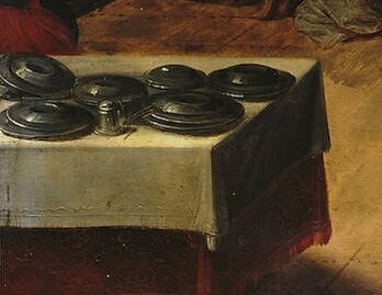 A mundane detail that grounds the scene in reality, hinting at the feast or meal that preceded or will follow the dance.