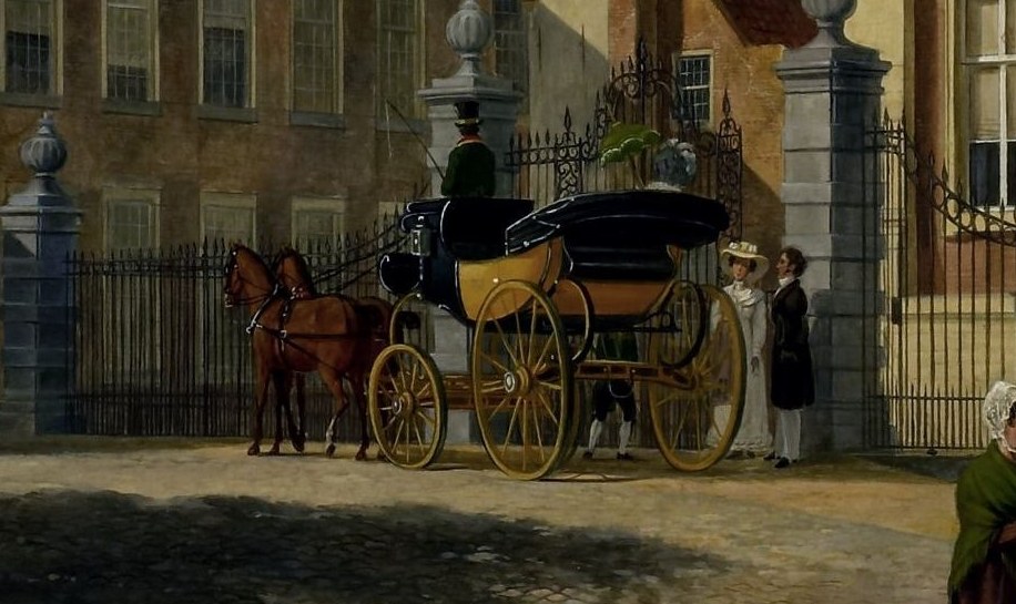 A horse-drawn carriage passes over the worn cobblestones.