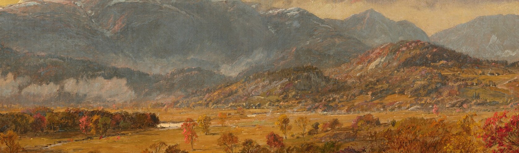 Sunlight breaks through, lighting a misty, distant valley.