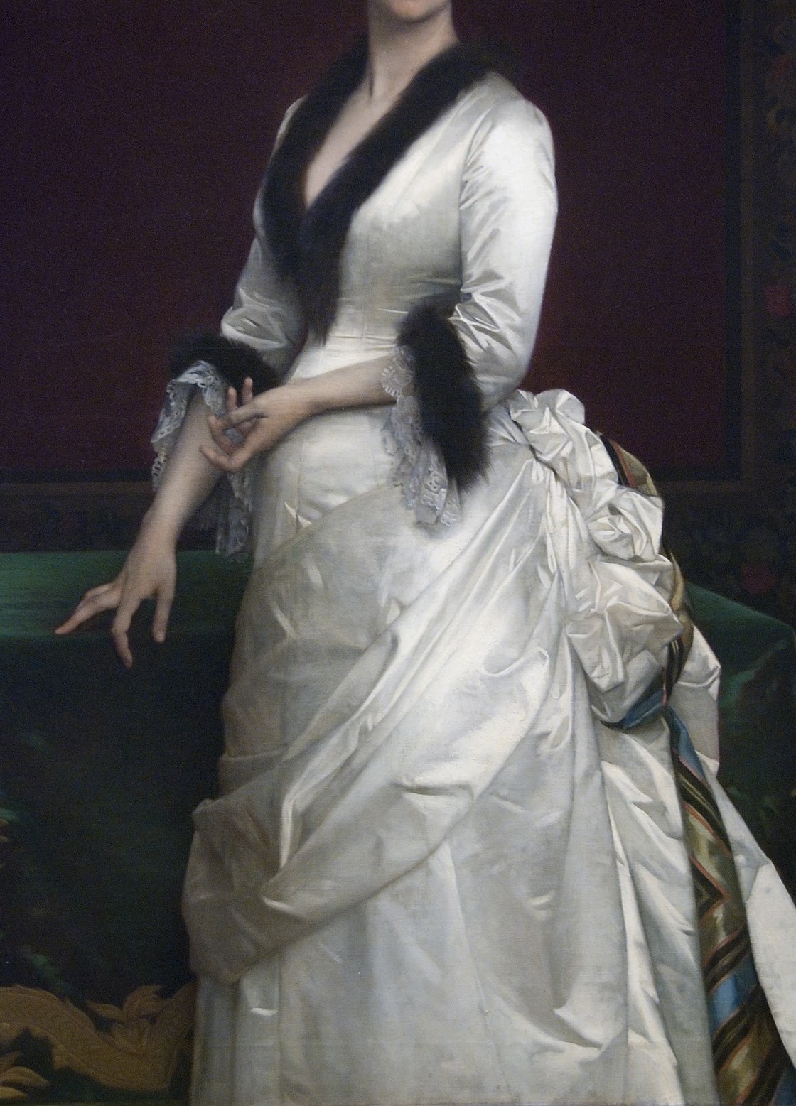 The dominant surface of the painting , Cabanel exploits satin's directional highlights to display academic bravura; the sheer volume of cream-white fabric was itself a status marker in 1880s Gilded Age portraiture.