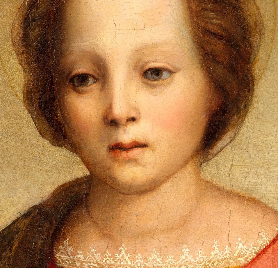Her gaze holds a quiet sorrow.