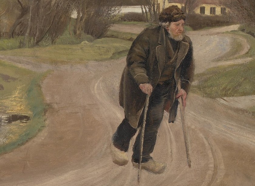 He leans on two crutches, struggling forward.