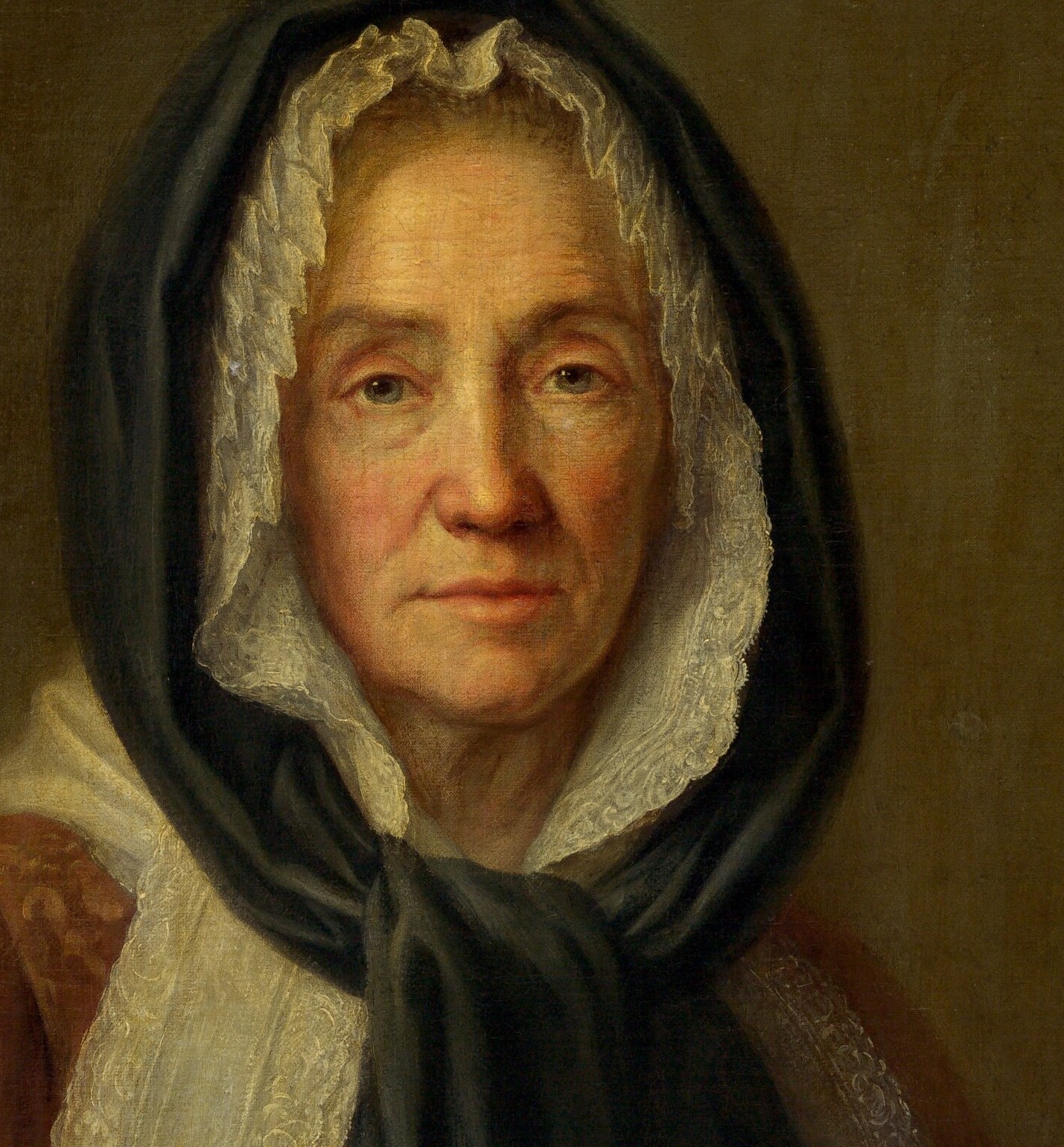 The deep shadow of the hood frames her face, emphasizing her isolation and inner world.