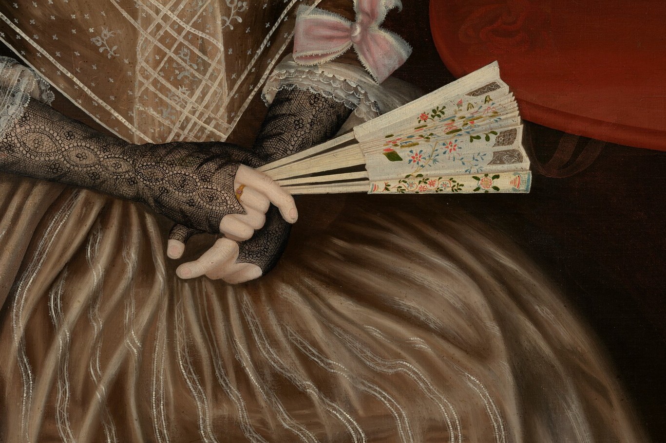 She holds a painted fan. A costly prop for a portrait.