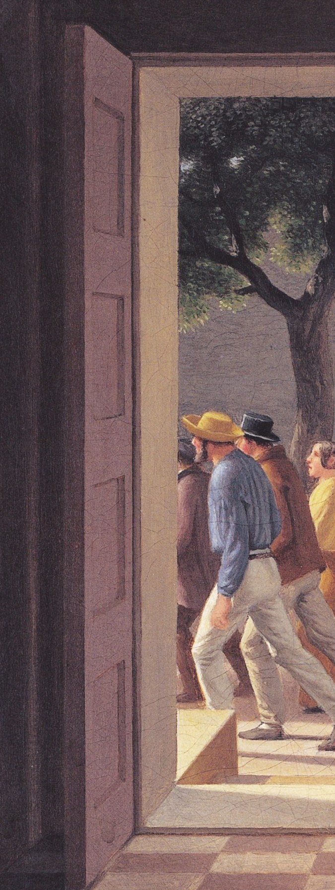She stands in a doorway, shielding her eyes from the sun.