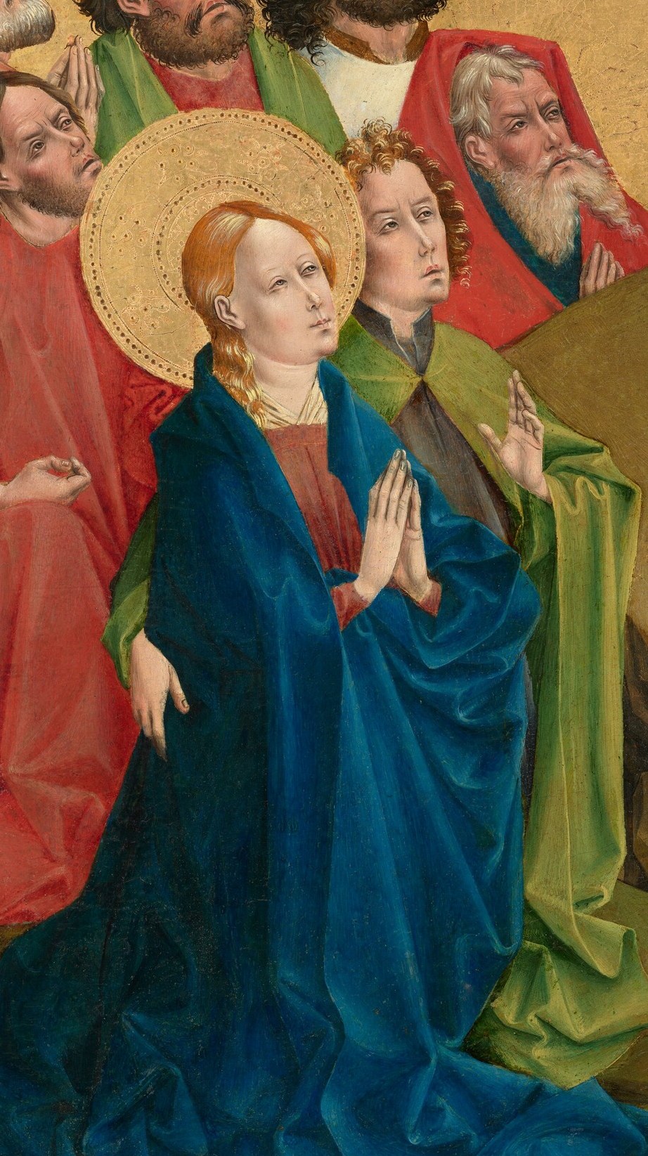 Her posture of prayer and devotion highlights her central role and emotional connection to the event.