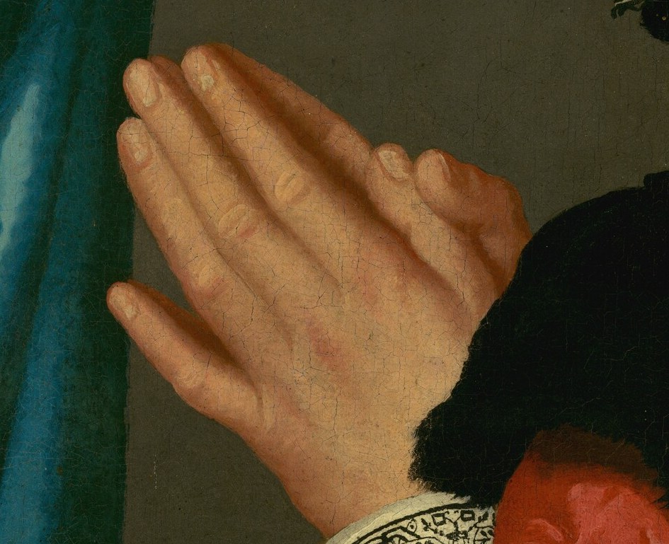 His hands, clasped, show deep humility and piety.