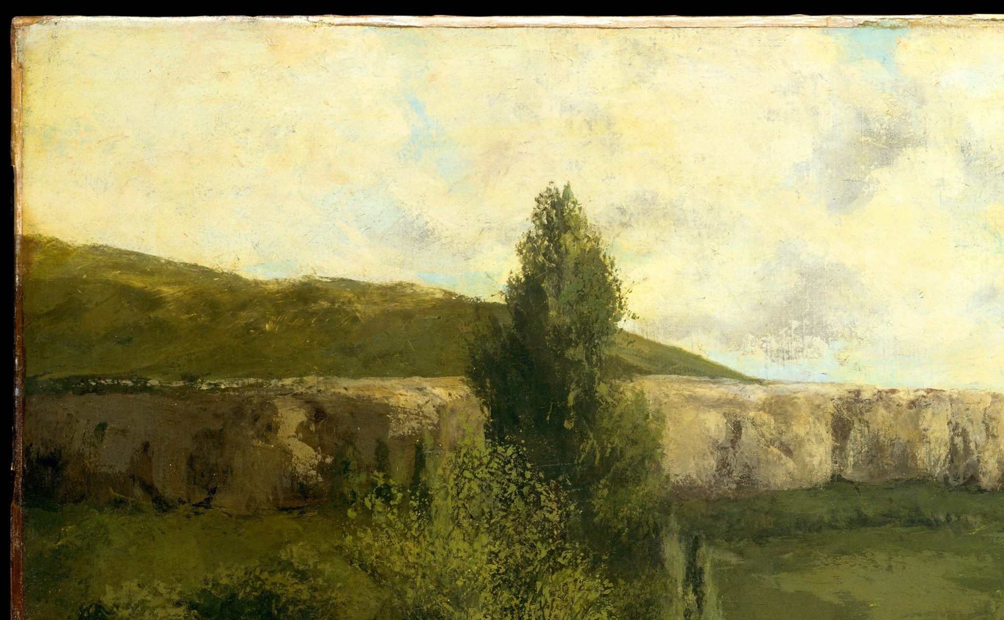 Freely painted in greens and ochres, the hillside shows Courbet's proto-Impressionist looseness; its unidealized ordinariness was radical in 1855.