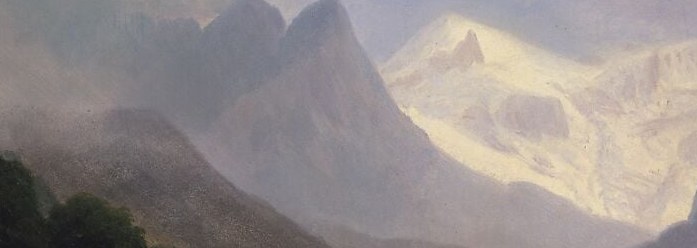 The mist wraps the mid-slope in cool grey.