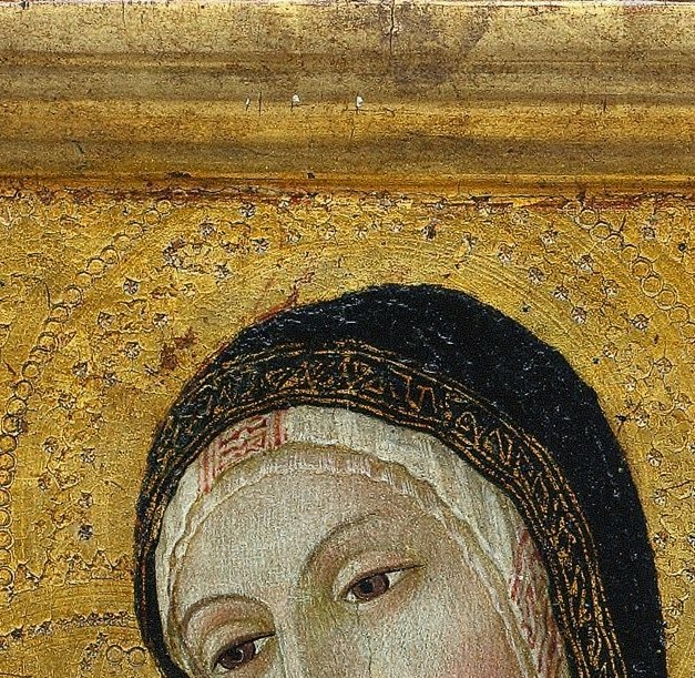 The Virgin looks down, heavy-lidded, impossibly calm.
