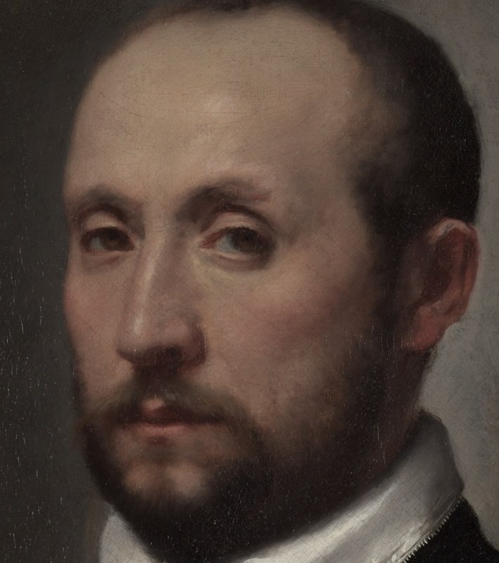 His direct gaze conveys his serious and composed presence.
