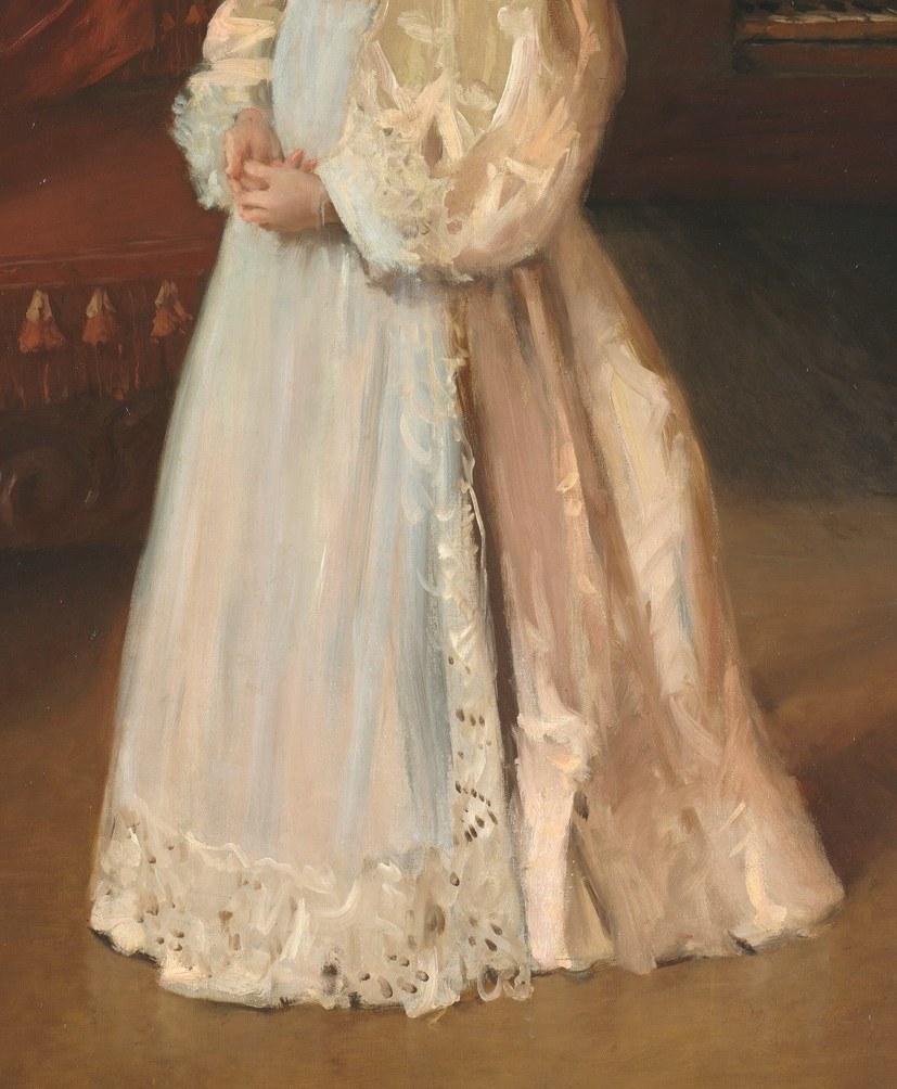 Her white dress has delicate lace.