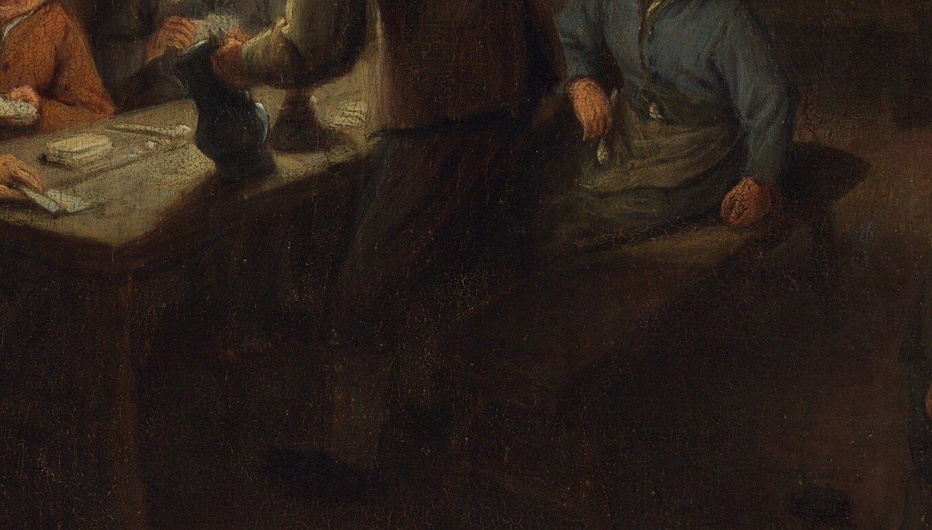 Around the table, men focus intently on a card game.