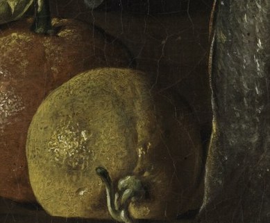Their vibrant color and dimpled skin provide a contrast to the muted tones of the other objects.