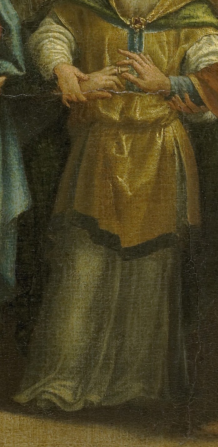 He wears gold, signifying his status.