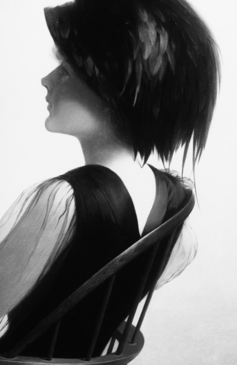She sits in quiet contemplation, watching something outside the frame.