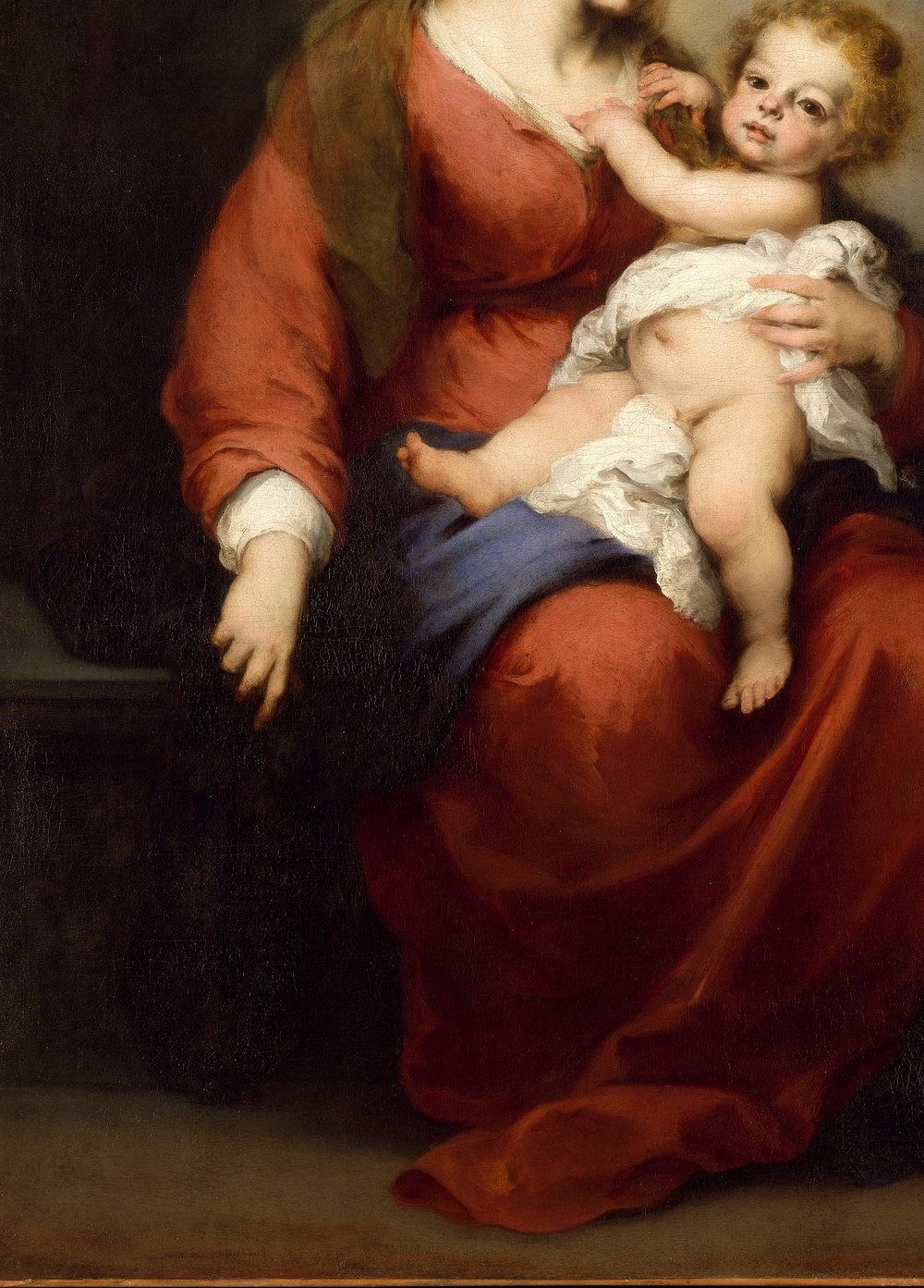 The red of her dress already holds the story of the Passion.
