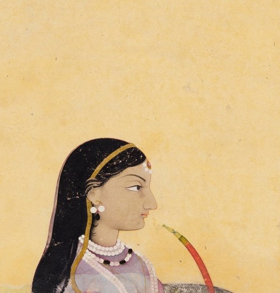 Her jewelry is specific: a maang tikka, strands of pearls.