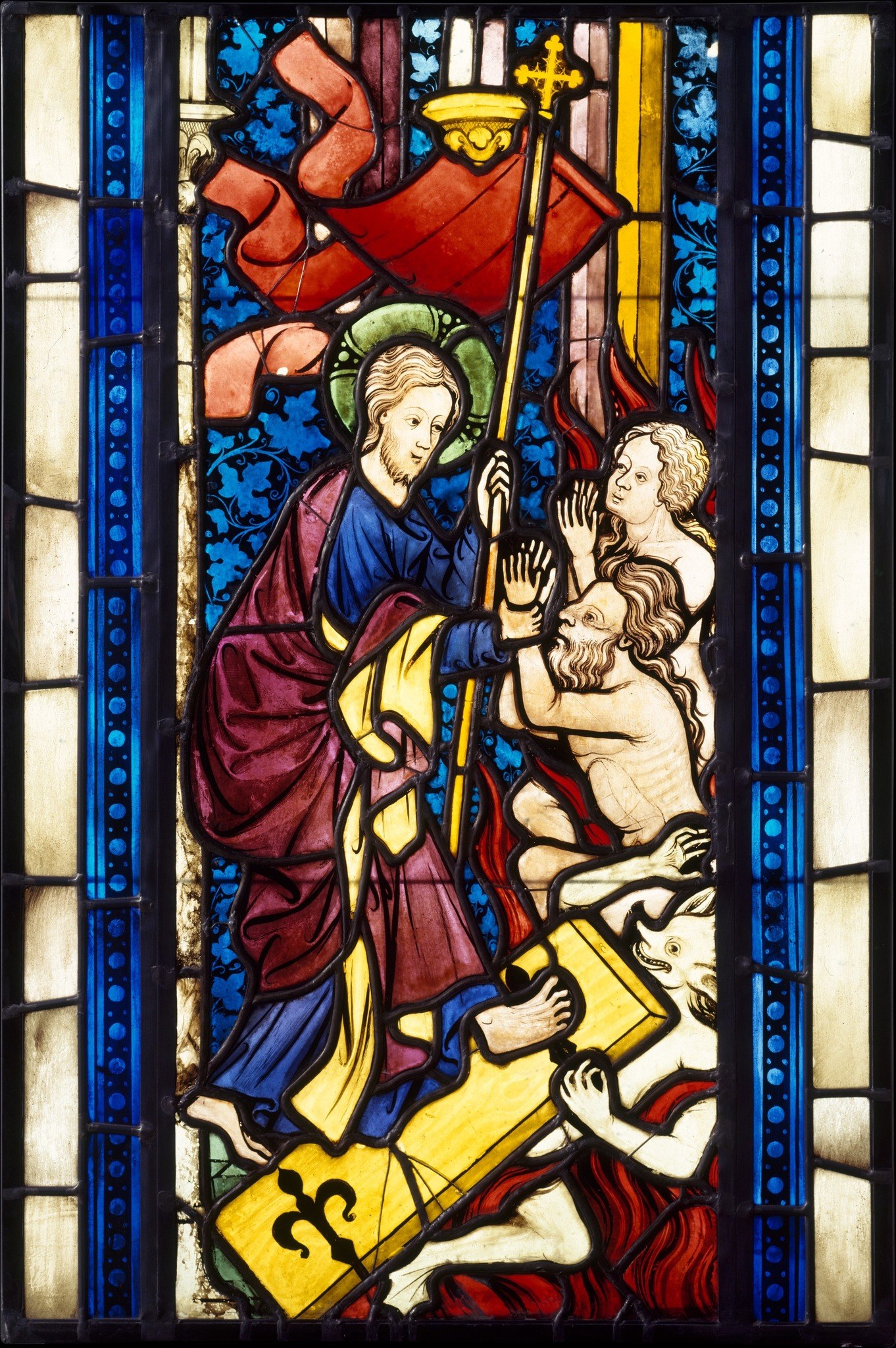 The visible lead lines are not just structural , they are compositional drawing. The glazier used cames to outline Christ's halo, the staff, and the figures' contours, making the metalwork itself part of the image.