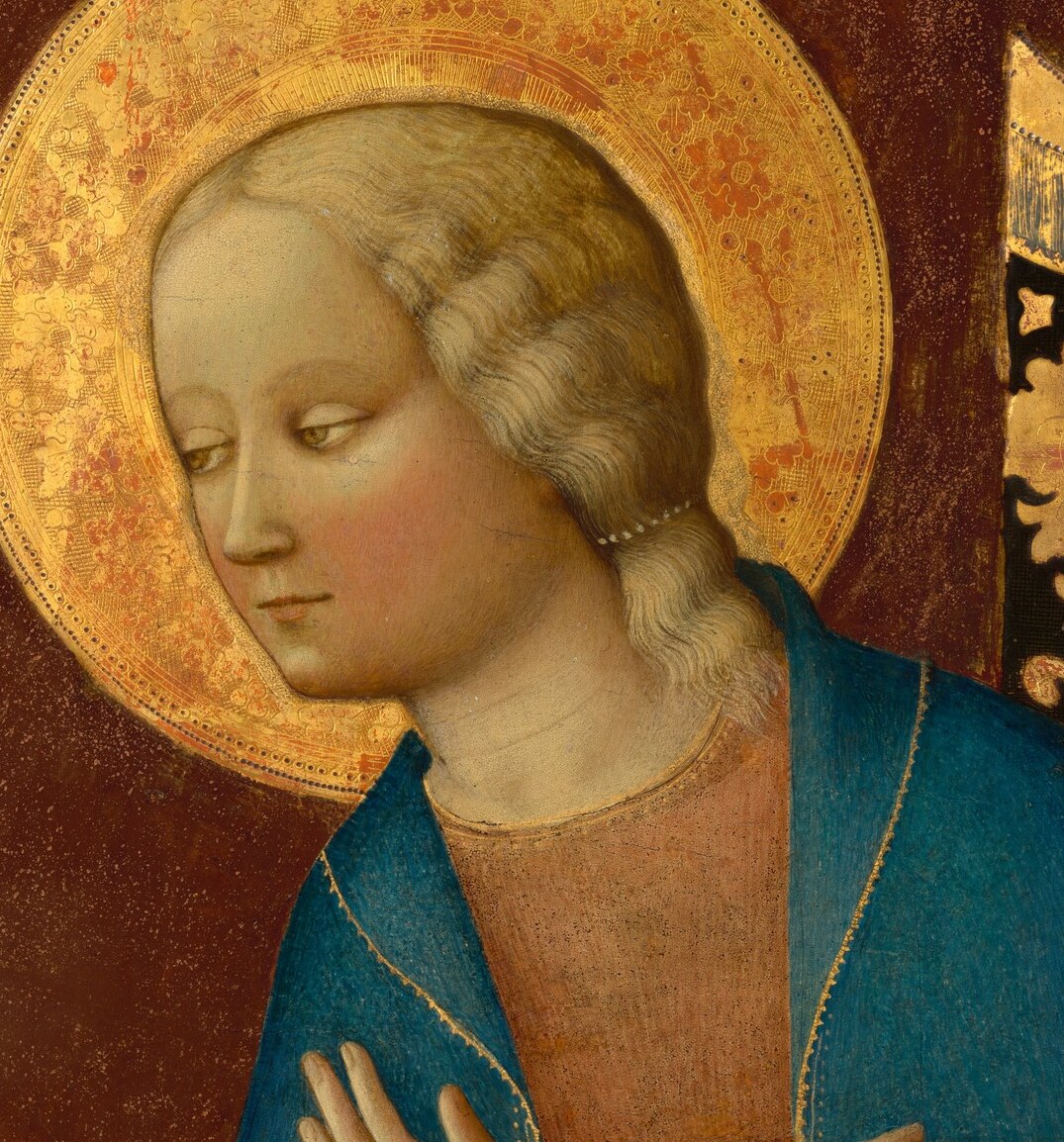 She wears a delicate halo, signifying divine status.