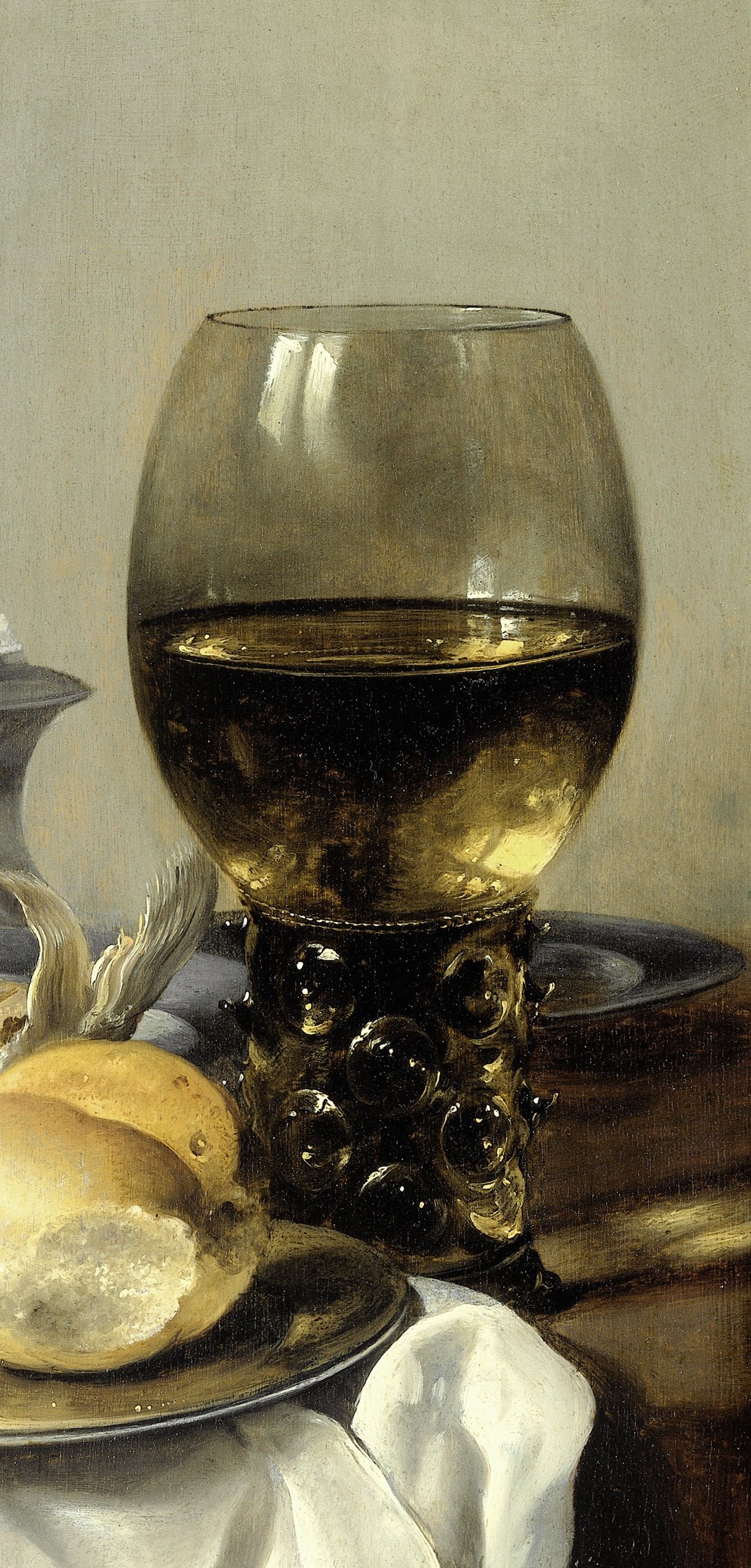 The dominant vertical element; the glass catches warm light and reveals the dark wine within, with raspberry prunts visible on the stem , a hallmark of Dutch golden-age glassware that dates the scene precisely.