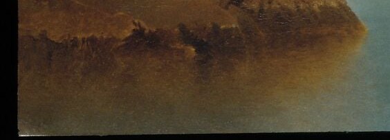 The water's surface reflects the sky with a mirror-like stillness.
