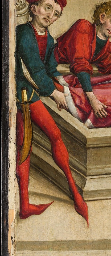 A loyal attendant bends over his feet in private grief.