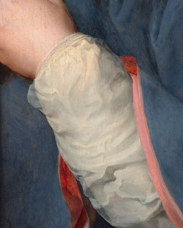 Now see his delicate white cuff, ruffled and sheer.