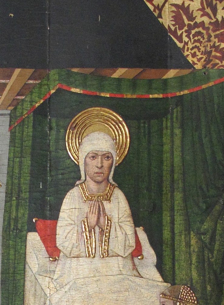 The central sacred figure , her white garments and luminous halo mark her as the miraculous elderly mother; her composed posture anchors the entire devotional scene.