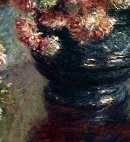 Its dark, reflective surface contrasts with the bright flowers, grounding the composition.