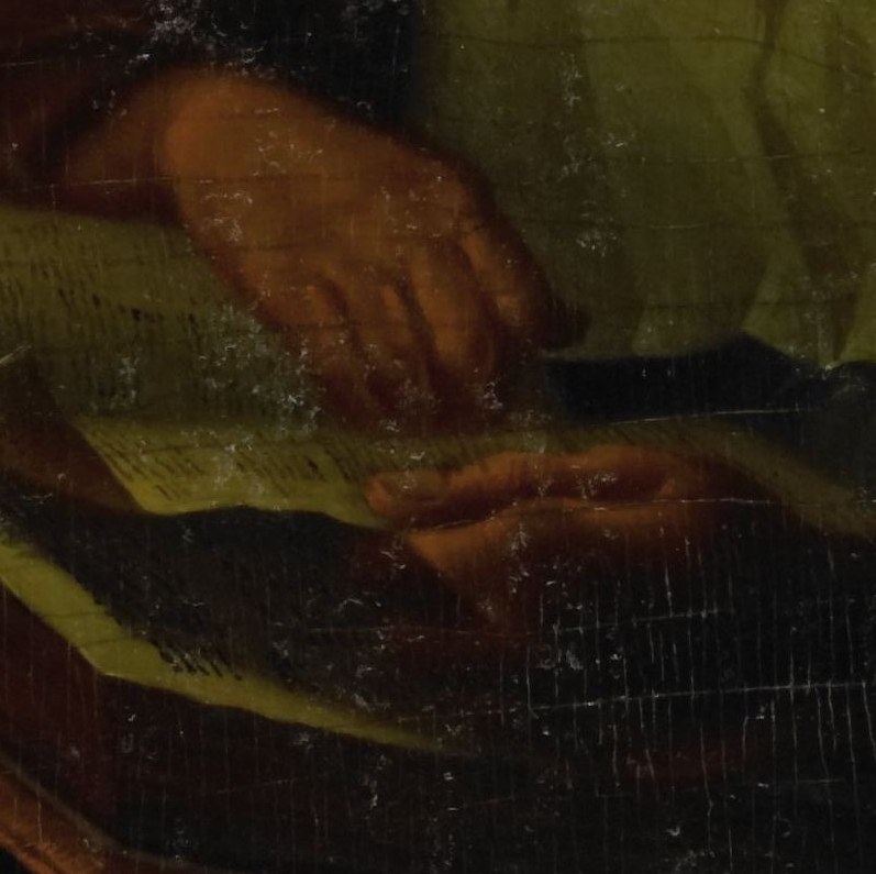 Her hands hold the open book.