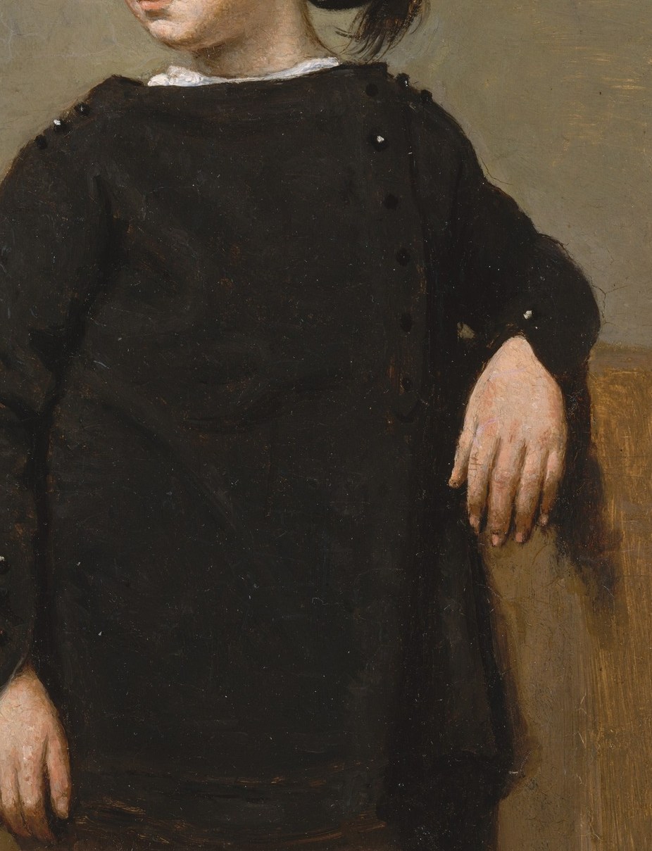 The simple, dark clothing emphasizes the boy's youth and innocence, making his expression the focal point.
