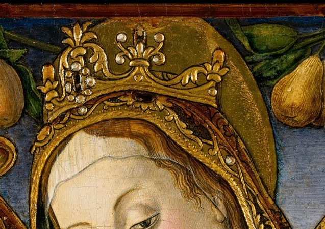 She wears a heavy crown. Her robe glitters with dozens of jewels.
