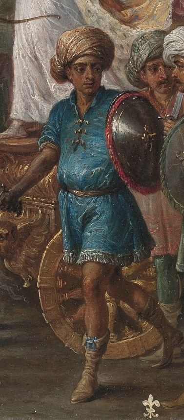 His direct gaze and prominent position suggest he is a key figure in Armida's entourage.