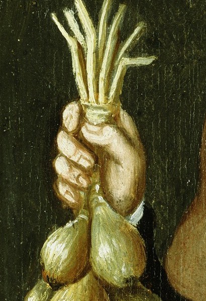 She grips a bundle of onions. This was real labor.