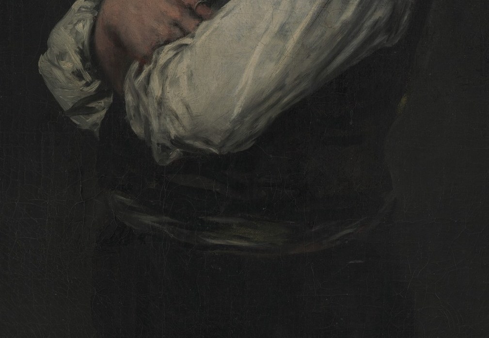 His arms are crossed, a posture of self-contained authority, very rare for a civilian then.