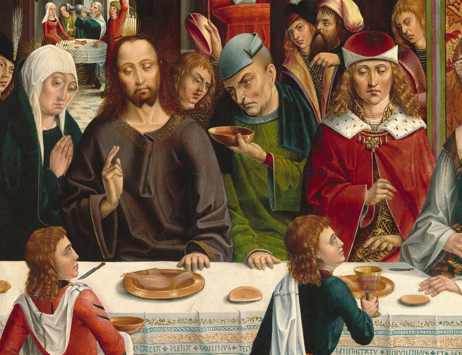 The feast is underway, with a richly dressed wedding party.