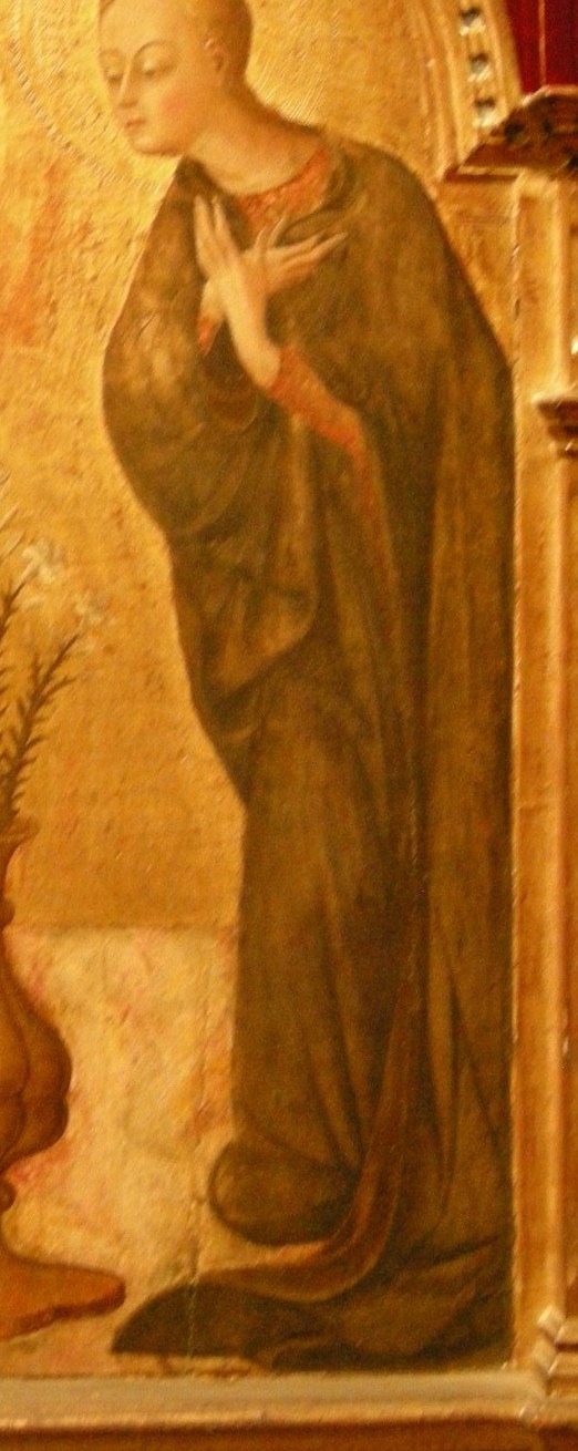 Her dark blue robe speaks of earthly humility.