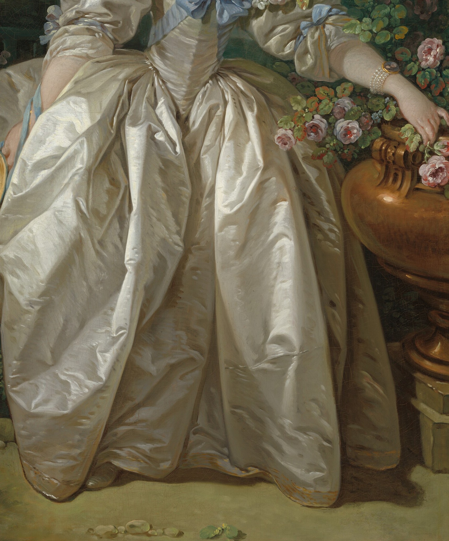 Her dress shimmers with voluminous folds of satin.