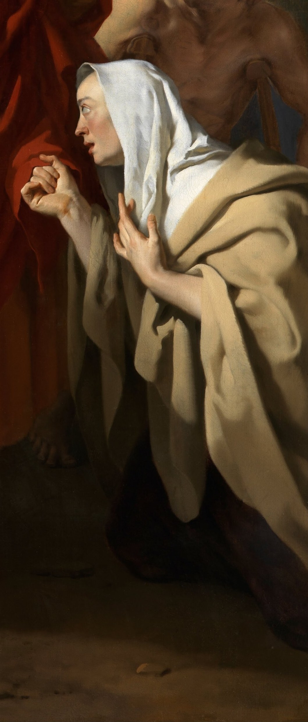 Light falls on this praying woman's face.