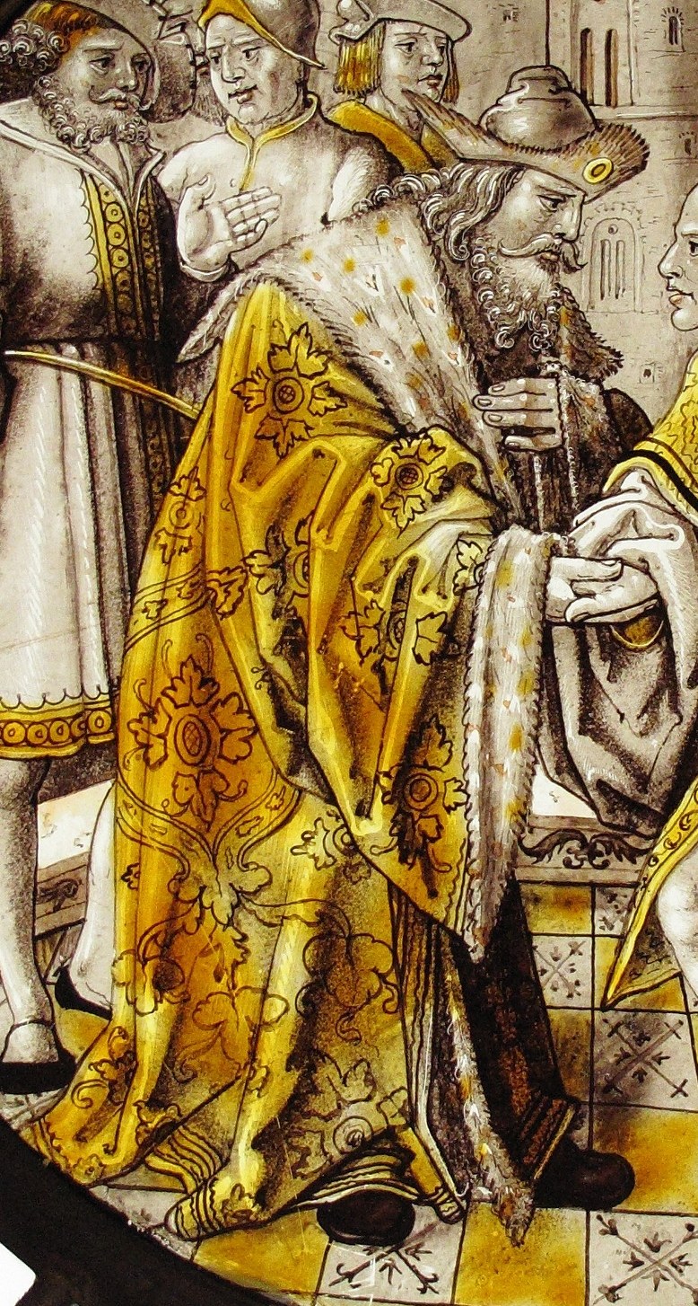 The father wears an elaborate, fur-trimmed robe.