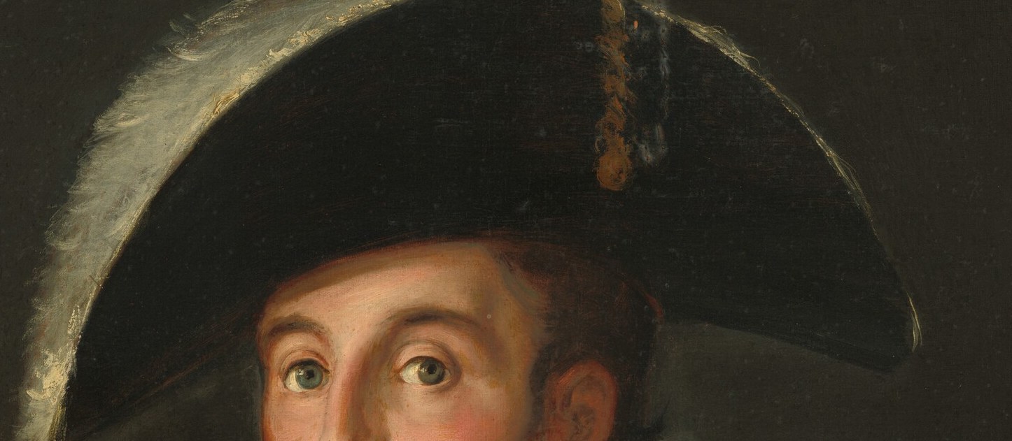 The hat's shadow emphasizes the intensity of his gaze.