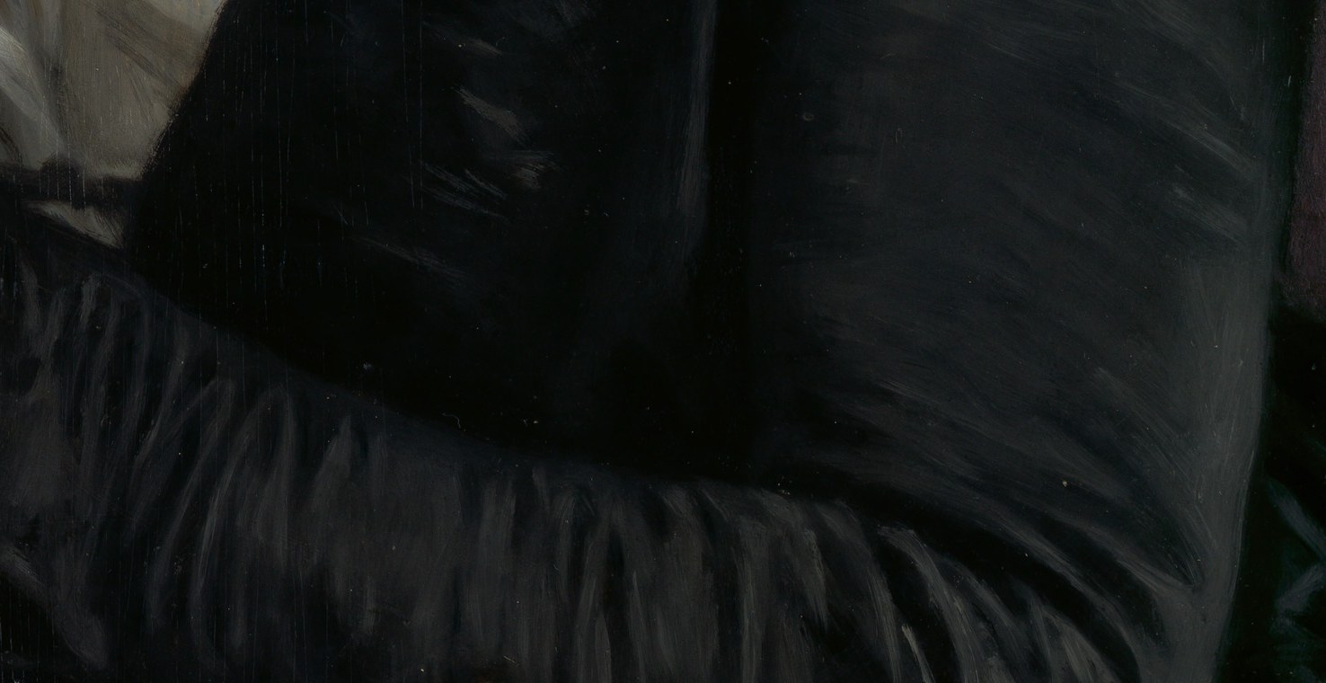 Notice her hands, gently resting on an open book.