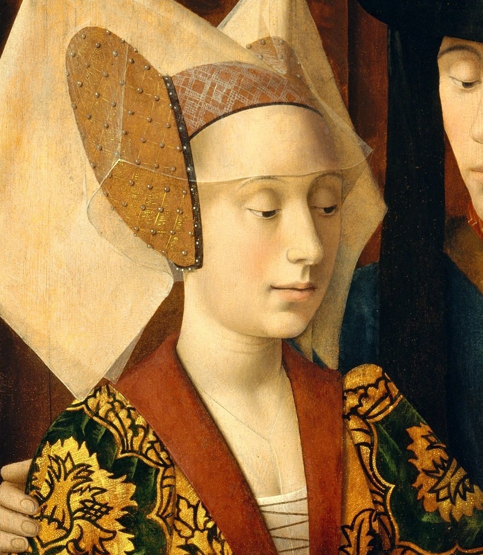 Her expression is attentive and composed , she watches the goldsmith closely, possibly as a prospective bride; the intimacy of her attention suggests this is a betrothal-ring transaction.