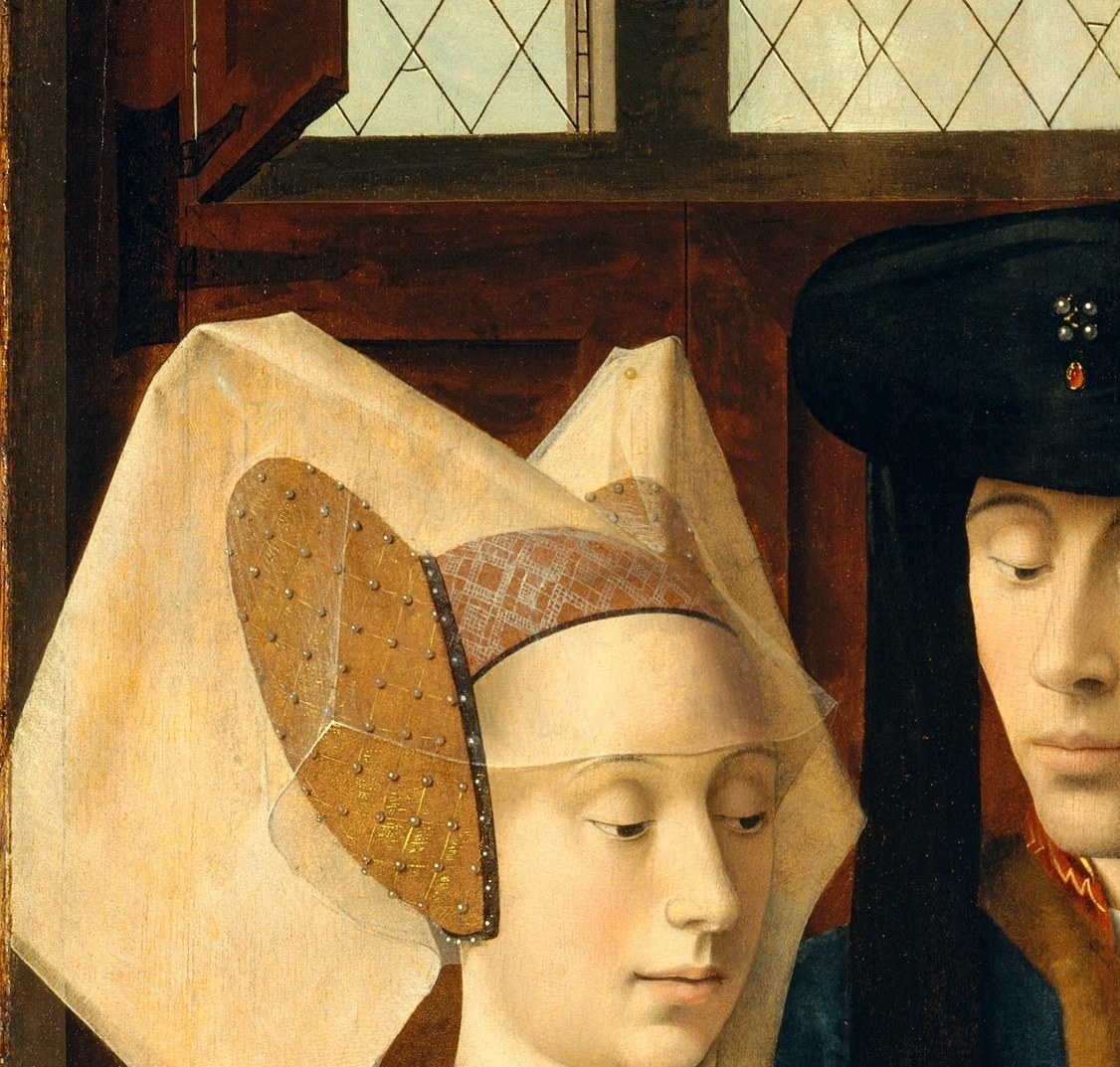 An elaborate Flemish horned/butterfly hennin; its opulent architecture signals high social status and anchors the painting's left third with strong graphic contrast against the dark background.