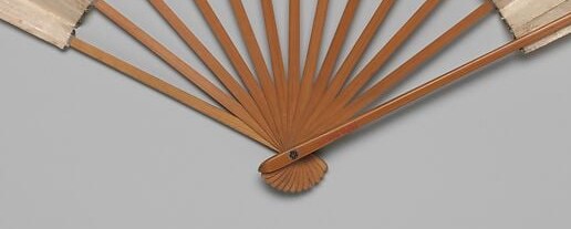 The radiating lines of the fan structure provide a geometric contrast to the organic forms of the flowers.