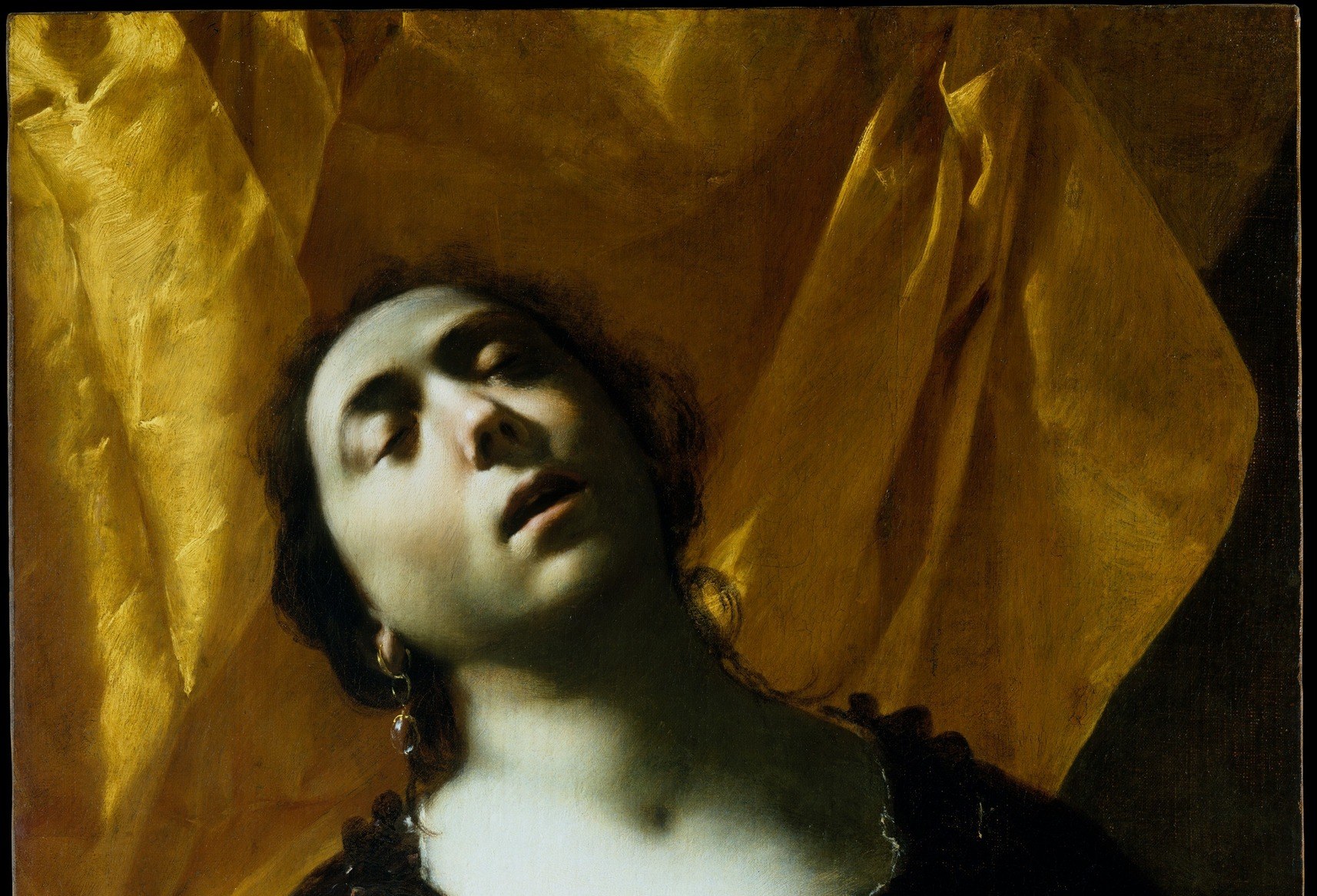 The dramatic light and shadow amplify her presence.