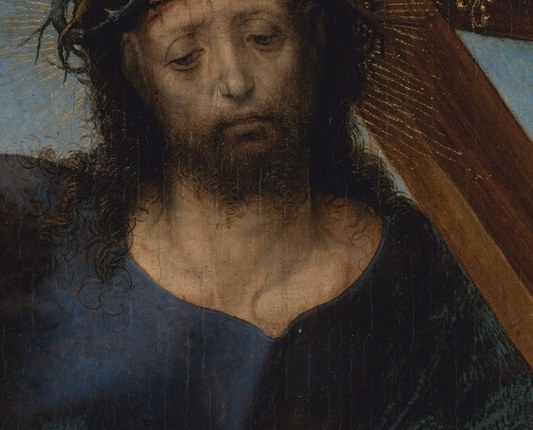 The parted lips suggest he is speaking, or struggling for breath.