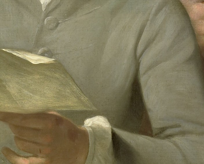 He holds a document, possibly an important commission.
